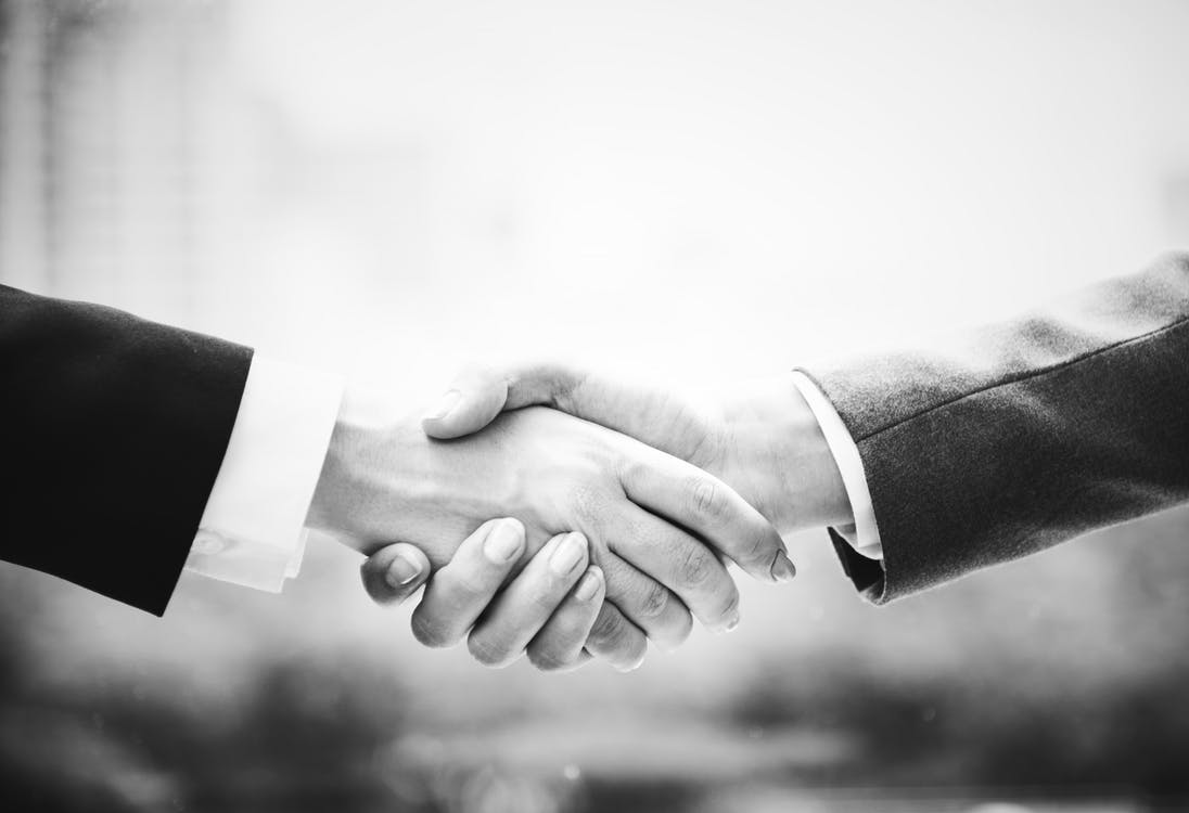 Black and white handshake with suites